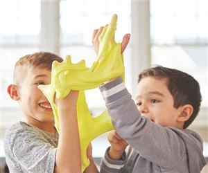 2 boys playing with yellow slime