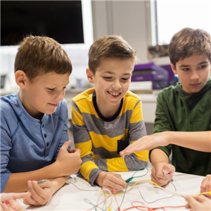 3 boys playing with wire