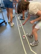 Children play a game to get ingredients to make their food.
