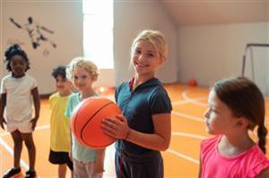 A young child gets ready to take a shot with their basketball