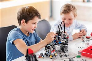 Children work together to build a LEGO robot
