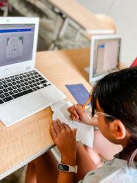 A student works on her computer during the Young Entrepreneurs Program.