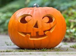 A carved pumpkin with a smiley design