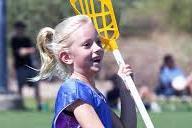 Girl smiling with lacrosse stick