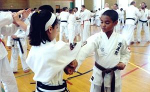 Young Boy and Girl Sparring in Karate